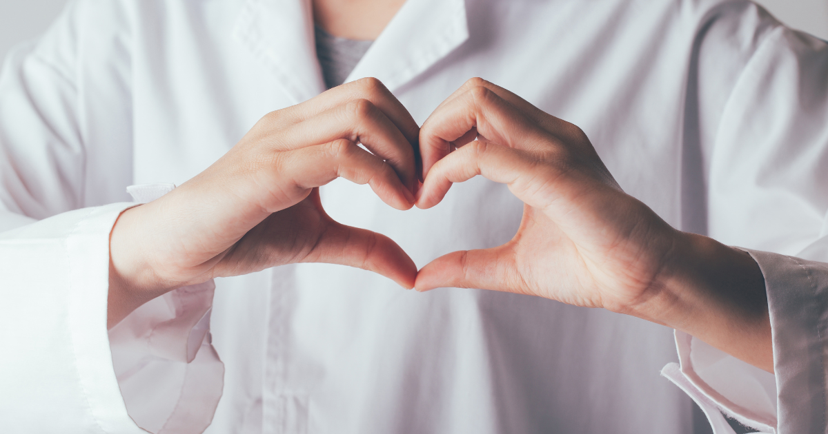 Close-up of doctor forming heart shape with hands, symbolizing compassionate concierge healthcare for preventative health screenings in Las Vegas