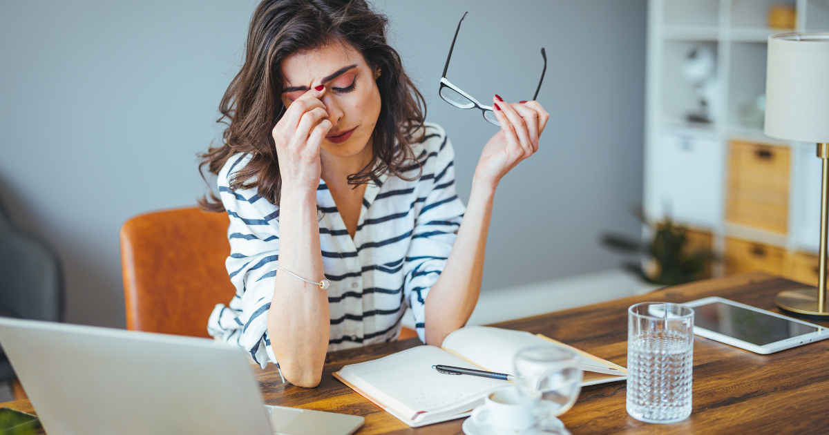 Professional experiencing burnout while working, representing stress and sleep support in Las Vegas