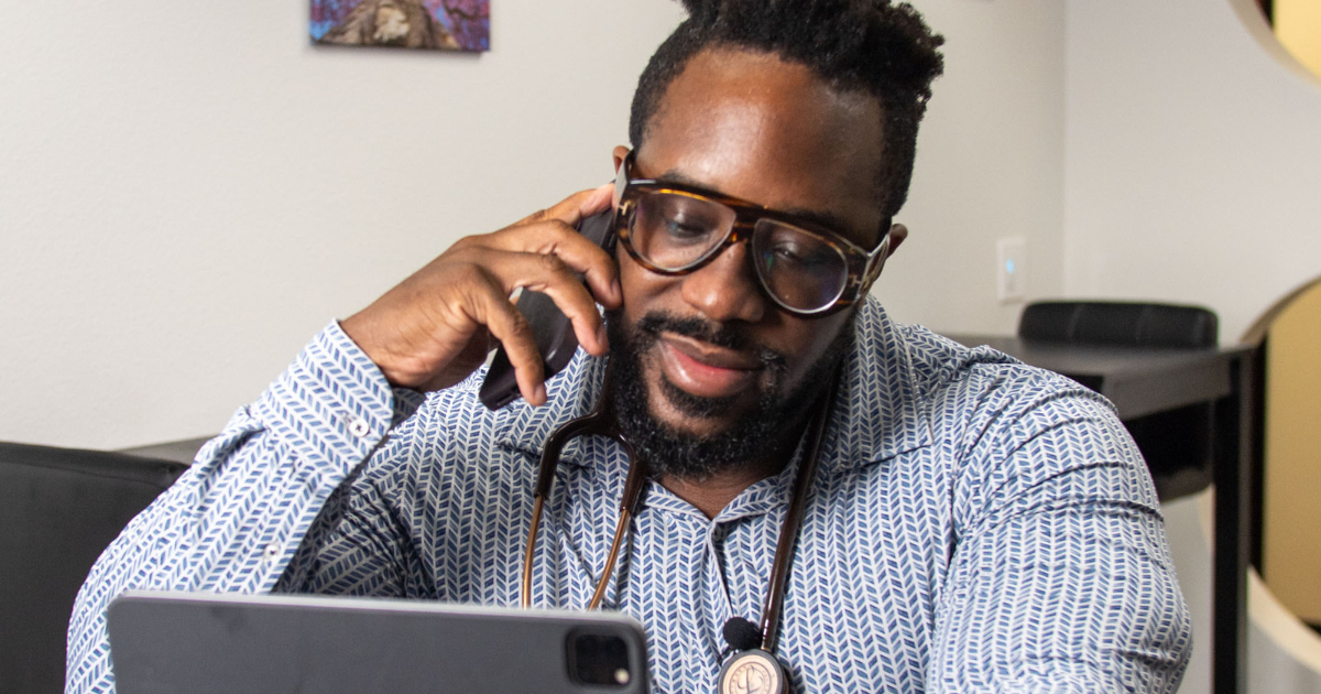 Concierge doctor in Las Vegas speaking with a patient by phone during a personalized healthcare visit, offering private physician care through Care Collective Concierge.