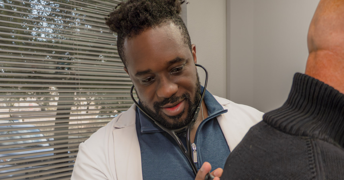 Physician at Care Collective Concierge performing a personalized medical examination during an insurance-free healthcare appointment in Las Vegas using a Concierge Direct Primary Care model.